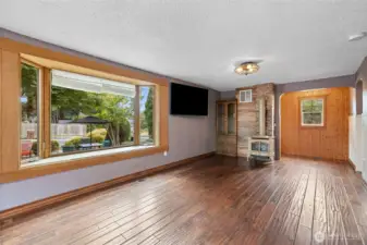 Large bay window overlooks patio space.
