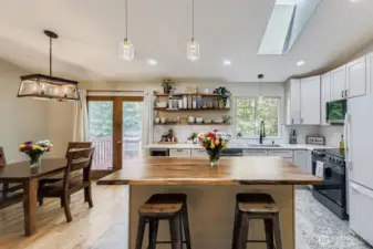 Chef's kitchen with updated cabinets, quartz counters, stainless appliance, bev fridge and show stopping butcher block island!