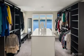 primary walk in closet with one of two laundry rooms