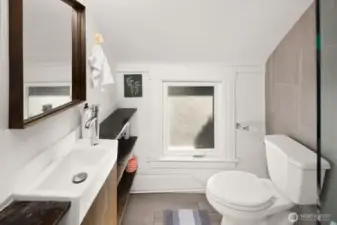 Unit #2015: Another view of the updated bathroom with built-in storage shelving.