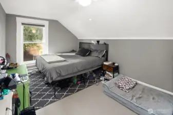 Unit #2011: Upstairs, this is the front bedroom, and largest of the three in this unit. Windows face both the front of the house (north) and the yard (west).