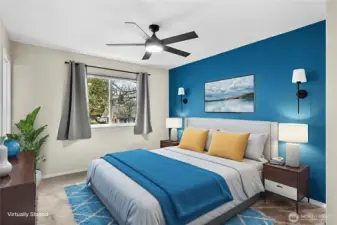 Primary bedroom with ensuite bathroom and walk-in closet. Virtually staged.