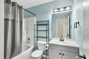 Upstairs guest bathroom with updated vanity, flooring and light.