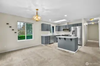 Kitchen with island seating and dining area.