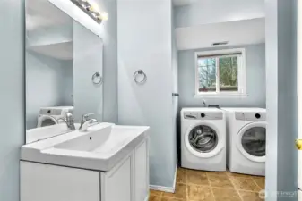 Downstairs 3/4 bath and laundry room. Front loading washer and dryer included in the sale.