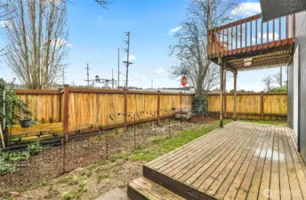 Side yard with garden space. Newer fence raps the entire backyard.