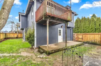 View of the backyard from the side yard. Newer fully fenced backyard.