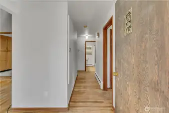 Interior hallway with original hardwood flooring and natural light.