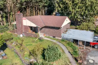 Not only is there a large 2-car carport, there is an additioanal 2-car garage under the home. One of the bays of the garage were used as a large shop area.