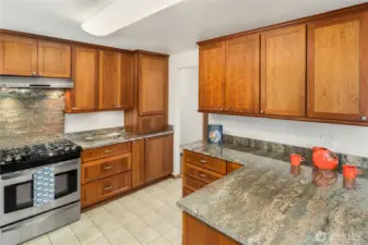 Kitchen cabinets were designed with lots of extras to maximize the space and enhance the cooking experience.