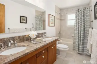 Double sinks and granite countertops.