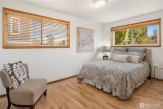 Large bedroom with east and north facing windows.