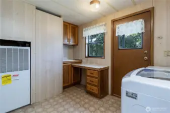 Laundry room with convenient work station and access to side porch entry.