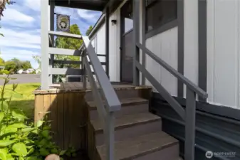 Small side porch perfect for BBQ, close to kitchen.