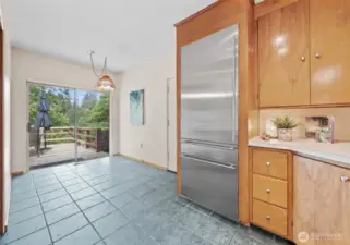 Stainless steel refrigerator. Kitchen nook for a desk or additional kitchen workspace.