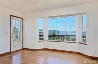 More windows and hardwood floors in the family room that is open to the kitchen