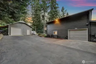 Detached garage and south side of the house at twilight.
