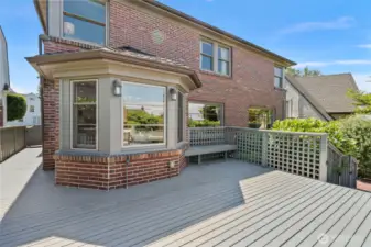Deck wraps around side of the home and to the backyard.
