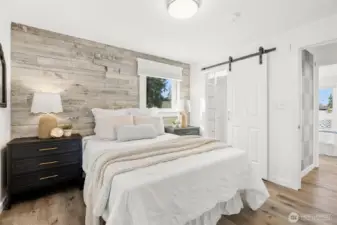 Primary bedroom with walk in closet with new barn door, all completely updated