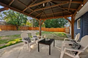 Covered pergola in backyard stays, perfect for entertaining outdoors with party lights!
