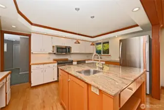 Plenty of countertops and storage and an island with sink for extra prep space!