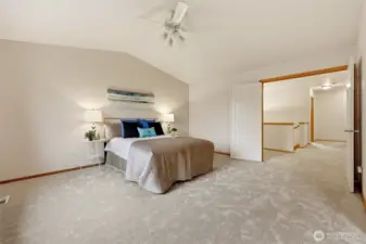 Vaulted ceilings and french doors add to the luxurious feel of this massive primary suite.