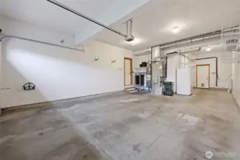 3-car tandem bay garage! Don't need all that parking space? Utilize the shelving for additional storage, or set up a shop space. The perfect extra space for hobbyists and enthusiasts of all kinds! Gas furnace and gas hot water heater, both meticulously maintained! Freezer and wine cooler included!