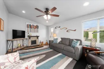 Another view of living room with furnishings and ceiling fan