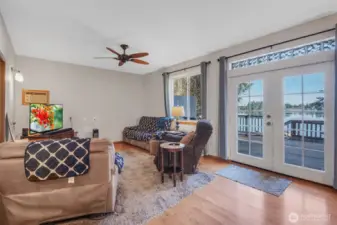 Main floor living room with deck access