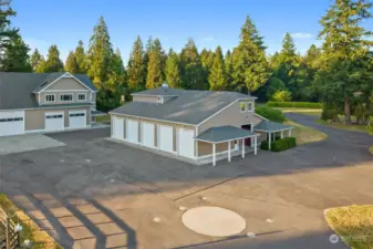 Helicopter landing pad. Building on the left is the "Helicopter Garage." Building on the right is the Barn w/ 3 stalls (plus room for more!) and 1 Bedroom Apartment above.