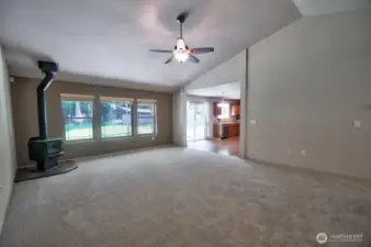 Large, light-filled living room with wood-burning stove.