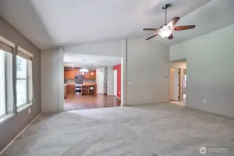 Living room showing dining/kitchen area and two bedrooms and full bathroom to the right.