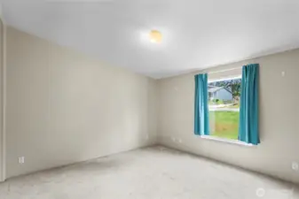 The second bedroom faces the front of the home and is a generous size.