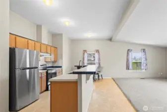 This well-equipped kitchen is full of bright light and plenty of counter space for prep, an elevated counter for entertaining or enjoying a casual meal with others.