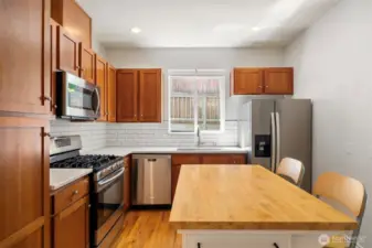The kitchen has granite counters and shaker-style cabinets with a tile backsplash.