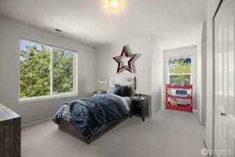 Looking at the virtually staged bedroom with the two dormer alcoves.