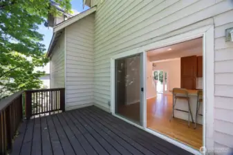 Looking from the deck toward the front entry beyond the kitchen and dining area.