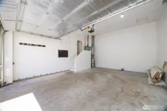 The garage is where the gas forced air furnace is tucked in beyond the stairway.