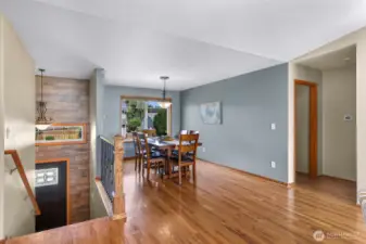 Large windows frame this bright dining area, offering peaceful neighborhood views and an inviting backdrop for morning coffee or dinner parties.