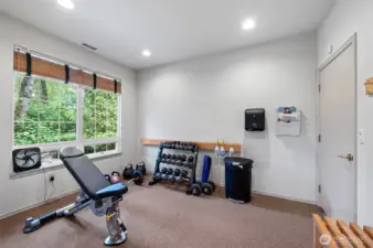 Well-equipped weight room with free weights, kettlebells, and resistance training equipment — all part of the resort-style amenities at Sundance at Klahanie.