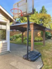 Large backyard with a covered gazebo and plenty of room for kids to play or to set up a basketball hoop for family fun.