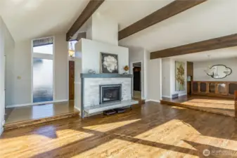 Lovely gas fireplace with stone surround. Gorgeous exposed beams & updated hardwood floors.