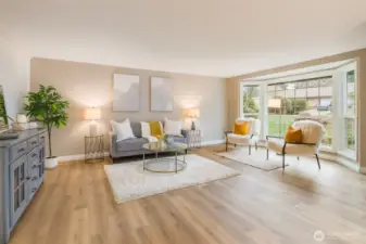Spacious main living area offers excellent natural light, durable waterproof LVP flooring, and flexible space for both everyday living and large gatherings.