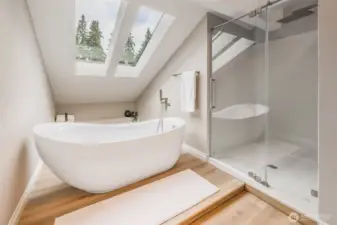 Spa-inspired primary bath features a stand-alone soaking tub, oversized 4x4 shower, quartz surfaces, and premium fixtures as part of the full studs-out remodel.