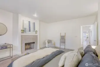 Cozy wood fireplace in the Primary suite.