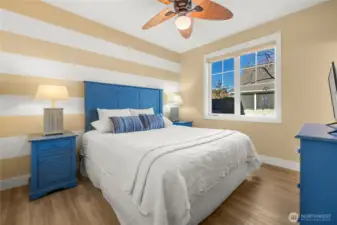 Primary Suite on main floor features designer paint. ceiling fan & more.
