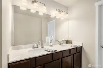 Generous en suite bath with double vanity and plenty of storage
