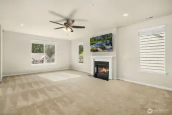 Spacious living room anchored by a cozy gas fireplace