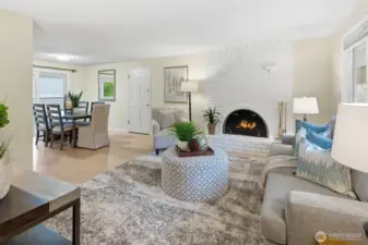 View from the front entry of the light and bright living room and dining room. The wood burning fireplace is gorgeous!