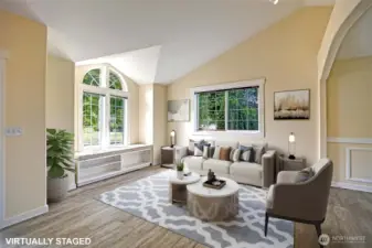 Living room with tons of light and built-in window seat.